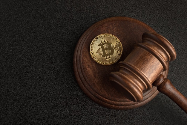 A gavel resting on a stack of Bitcoin coins, symbolizing the legal and regulatory oversight of cryptocurrency transactions under the Travel Rule.